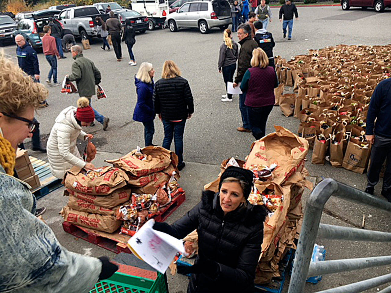 The South Everett-Mukilteo Rotary Club on Nov. 19 assembled 350 bags filled with all the fixings for a Thanksgiving feast to deliver to families in need. (Contributed photo)