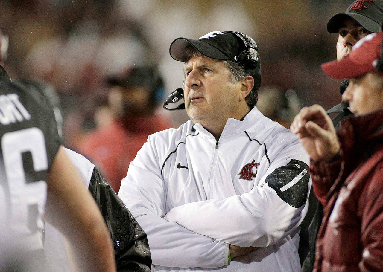 WSU football coach Mike Leach has led the Cougars to three straight bowl games. (AP Photo/Young Kwak, File)