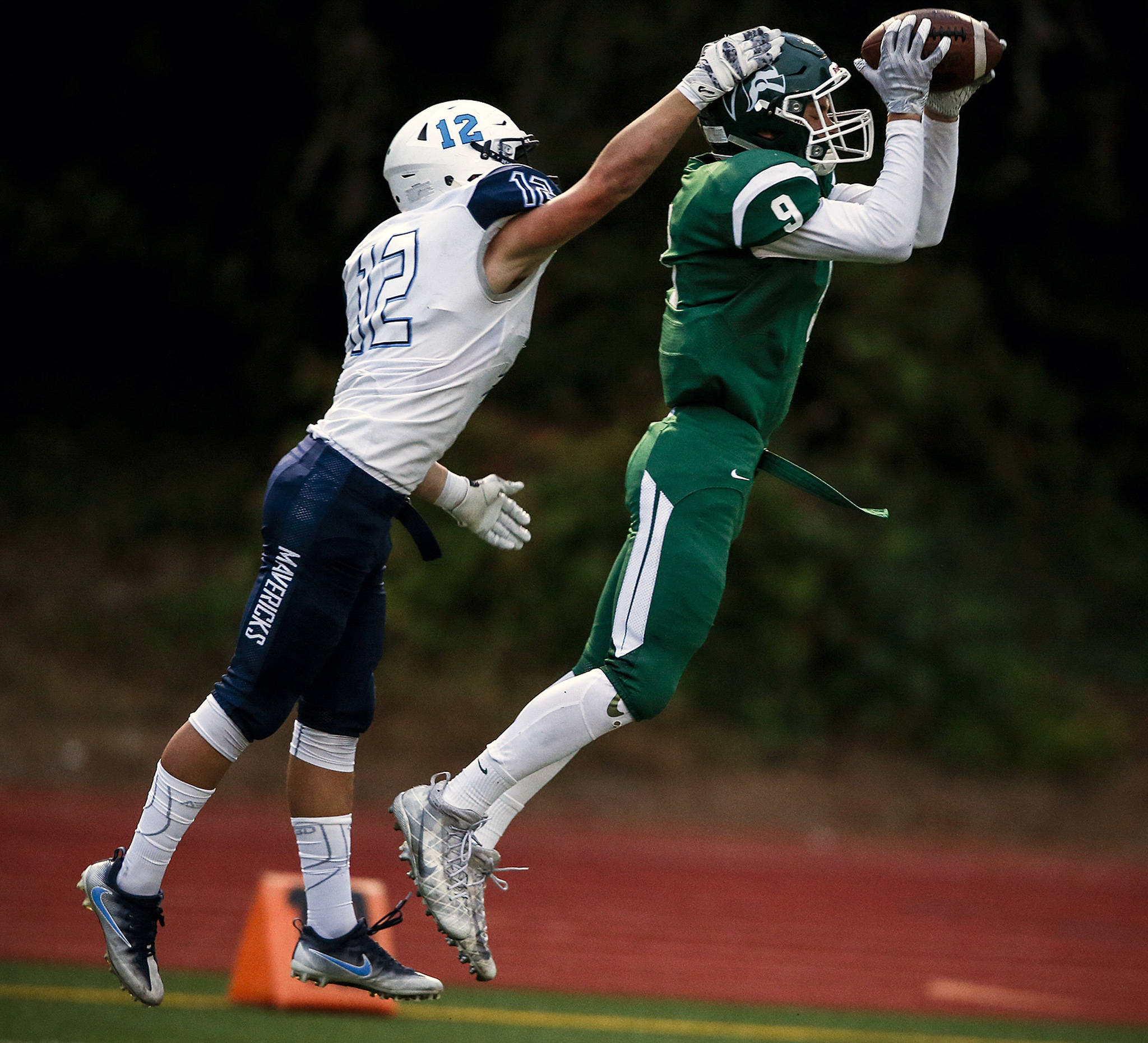 Edmonds-Woodway’s Noah Becker (9) intercepts a pass intended for Meadowdale’s Drew Harvey (12) during a game Oct. 6, 2017, at Edmonds Stadium. (Ian Terry / The Herald)