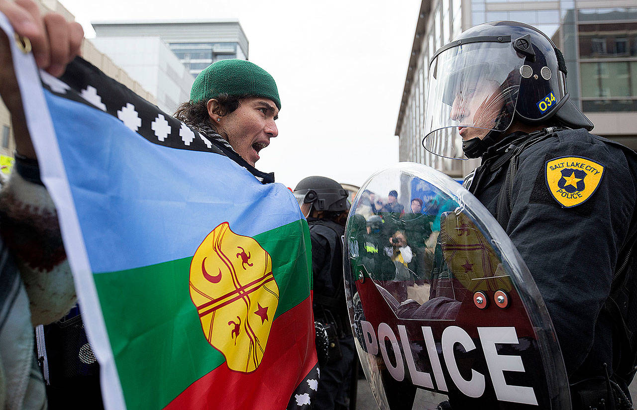 Anthony Fierro yells in front of a police officer in Salt Lake City on Monday as protesters are stopped from marching up State Street during President Donald Trump’s announcement to eliminate vast portions of Utah’s Bears Ears and Grand Staircase-Escalante national monuments. (Laura Seitz/The Deseret News via AP)