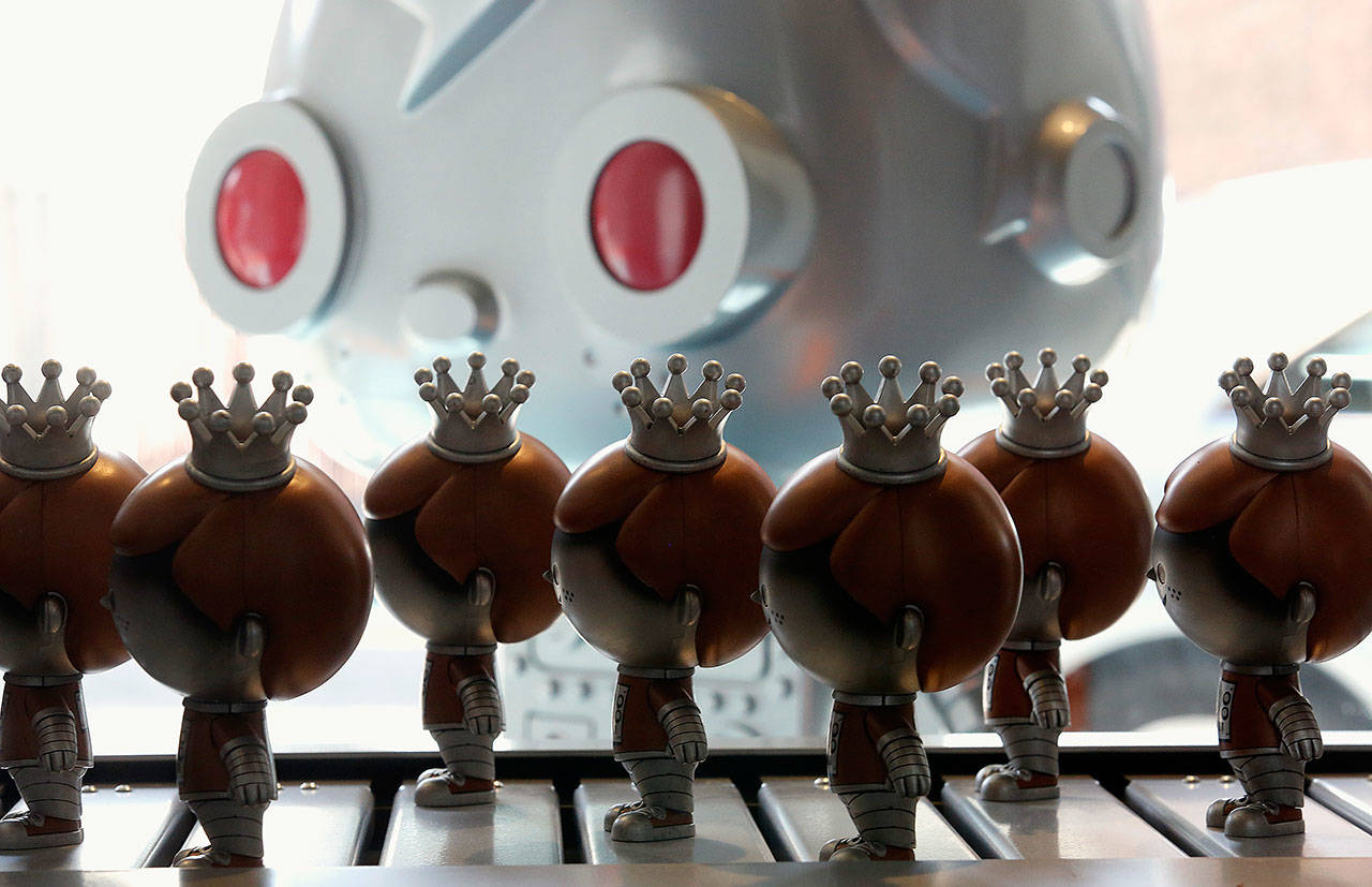 Freddy Funkos roll down a conveyor belt in the Pop! Factory of Funko’s Everett store in August. (Dan Bates / Herald file)