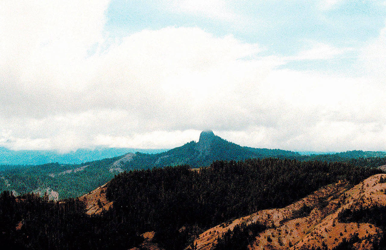 In this July 6, 2000, photo, Pilot Rock rises into the clouds in the Cascade-Siskiyou National Monument near Lincoln, Oregon. The Trump administration has agreed to resume litigation over the expansion of Oregon’s Cascade-Siskiyou National Monument on Jan. 15 unless it resolves the dispute first. (AP Photo/Jeff Barnard, File)