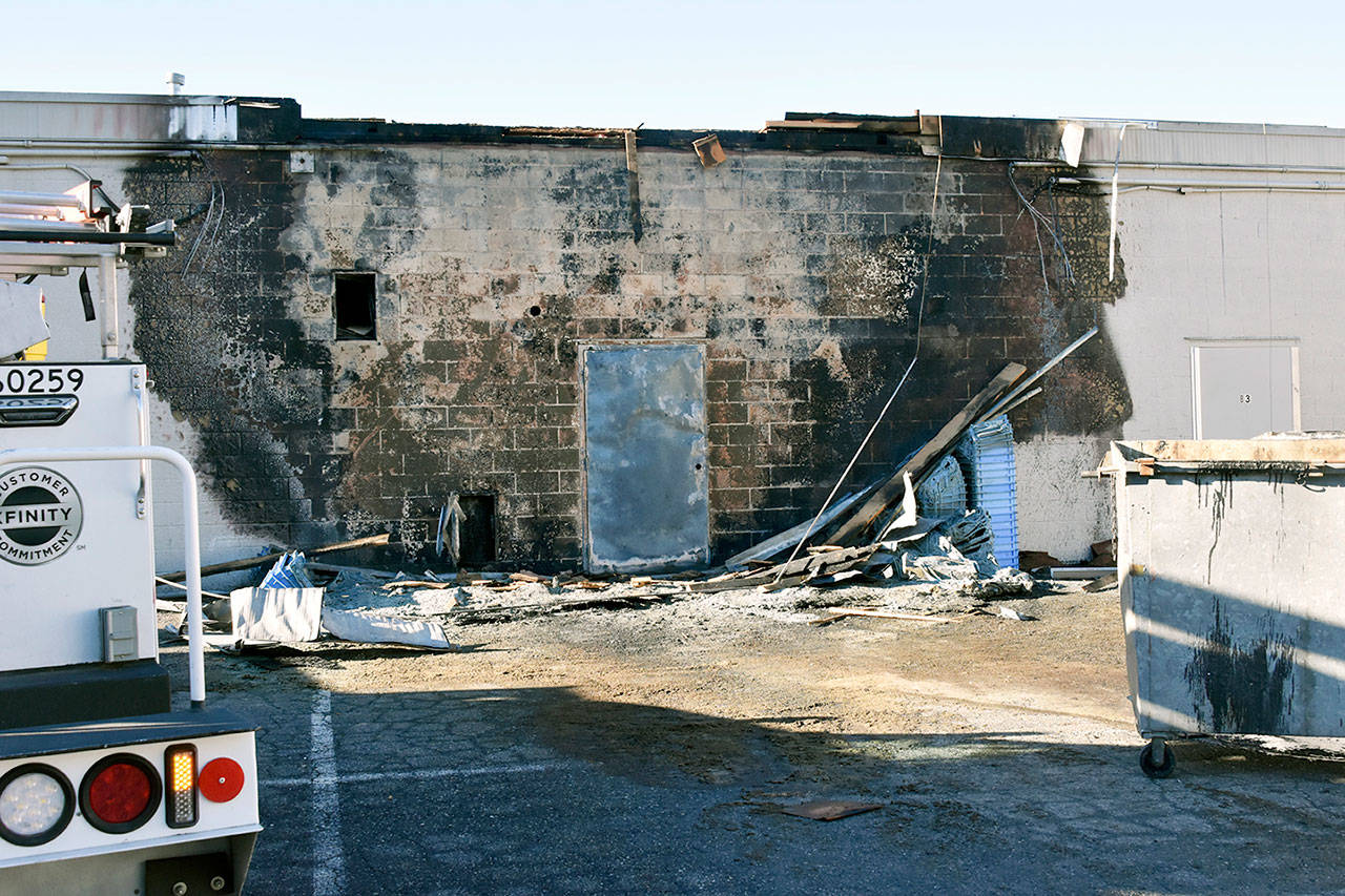 A garbage fire charred the back side of three businesses Wednesday morning along Evergreen Way in Everett. (Caleb Hutton / The Herald)