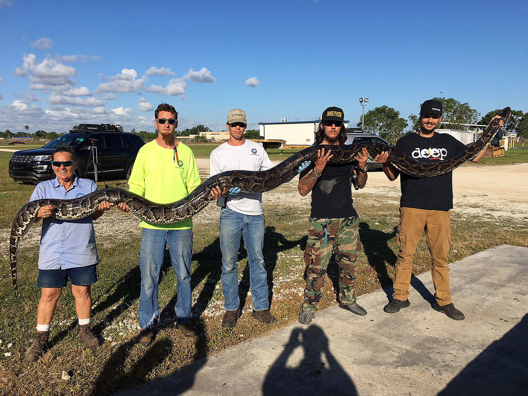 Three hunters caught a 17-foot, 132-pound Burmese python in the Florida Everglades in southern Miami-Dade, a record for the program aimed at curbing the proliferation of the non-native species. (South Florida Water Management District)