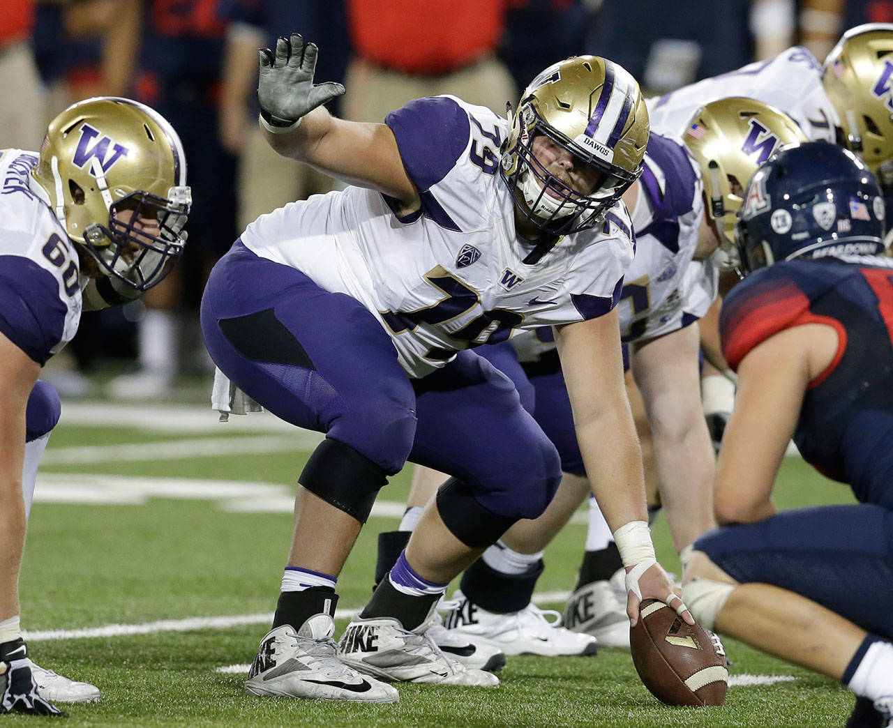 Washington center Coleman Shelton (79) gestures during the first half of a college football game against Arizona in 2016. Shelton was selected to the 2017 AP All-Conference Pac-12 team announced Thursday. (AP Photo/Rick Scuteri, File)