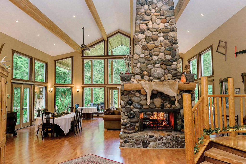 The giant river rock chimney and fireplace is the center piece of the Great Room at River Rock Inn. Guests are encouraged to grab a craft beer or glass of wine and warm their hands by the fire. (Photo courtesy of River Rock Inn)
