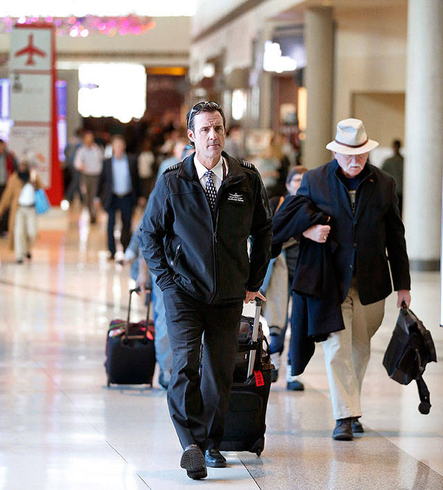 Southwest Airlines captain Mitch McDonald leaves the terminal after arriving on his flight at Dallas Love Field on Wednesday. (Tom Fox/The Dallas Morning News)