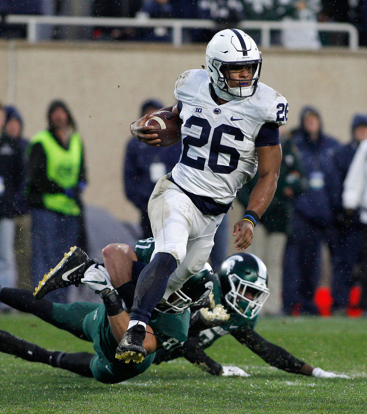 Penn State’s Saquon Barkley (26) is stopped by Michigan State’s Matt Sokol on a punt return during the first half of a game Nov. 4, 2017, in East Lansing, Mich. (AP Photo/Al Goldis)