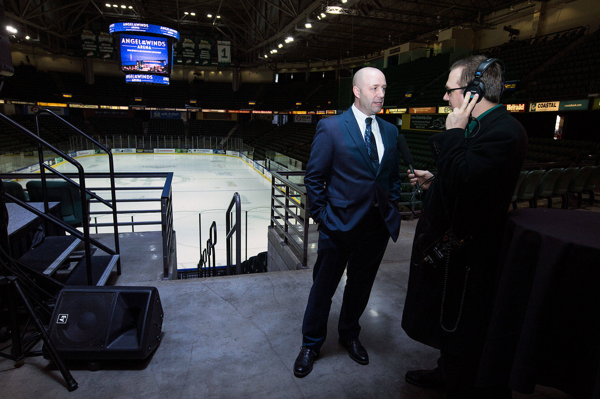 With the new name on the scoreboard, Angel of the Winds Arena General Manager Rick Comeau is interviewed after a renaming ceremony on Wednesday in Everett. (Andy Bronson / The Herald)