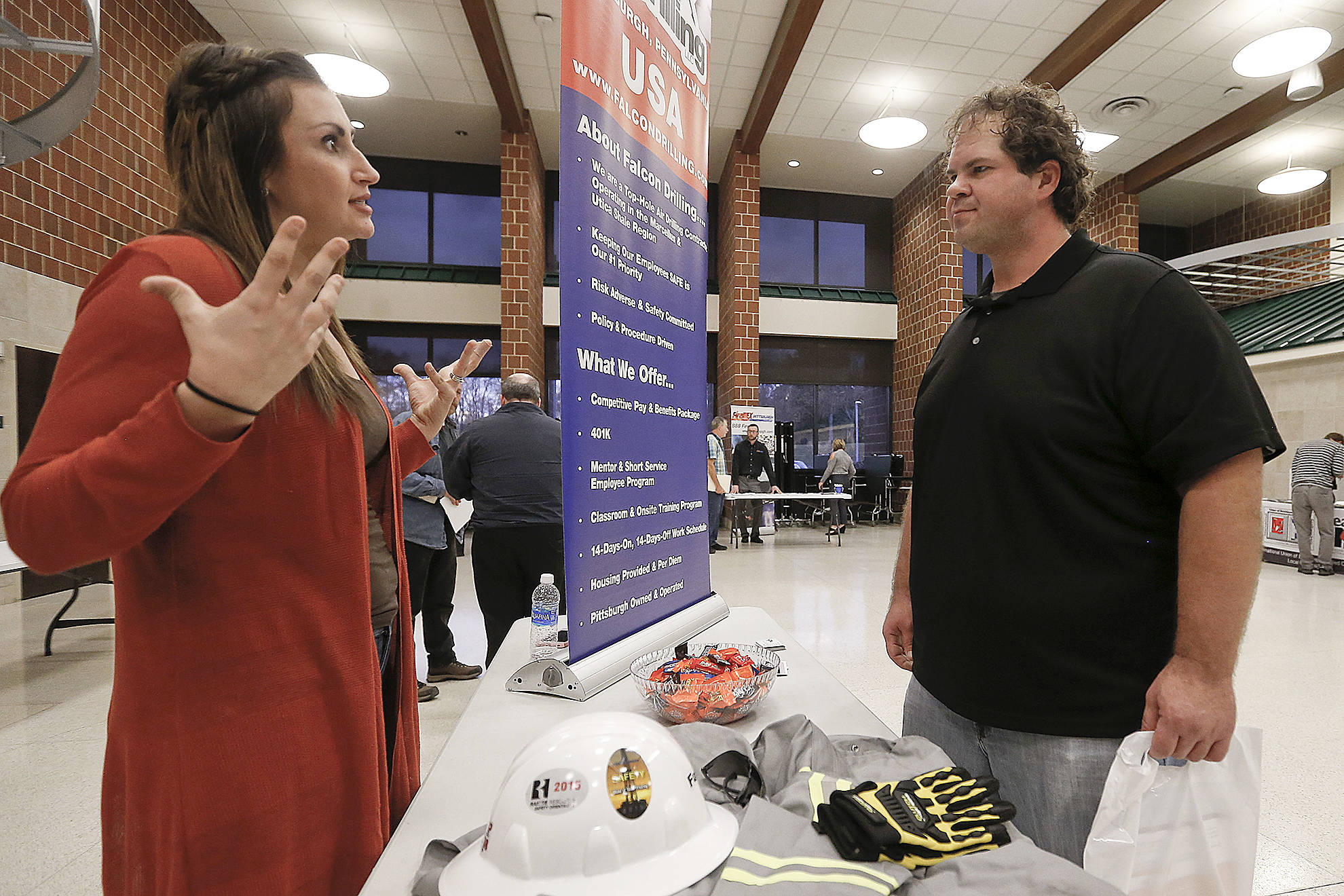 Keith Srakocic / Associated Press                                A recruiter from a driller in the shale gas industry (left), speaks with an attendee at a job fair in Cheswick, Pennsylvania, in November.