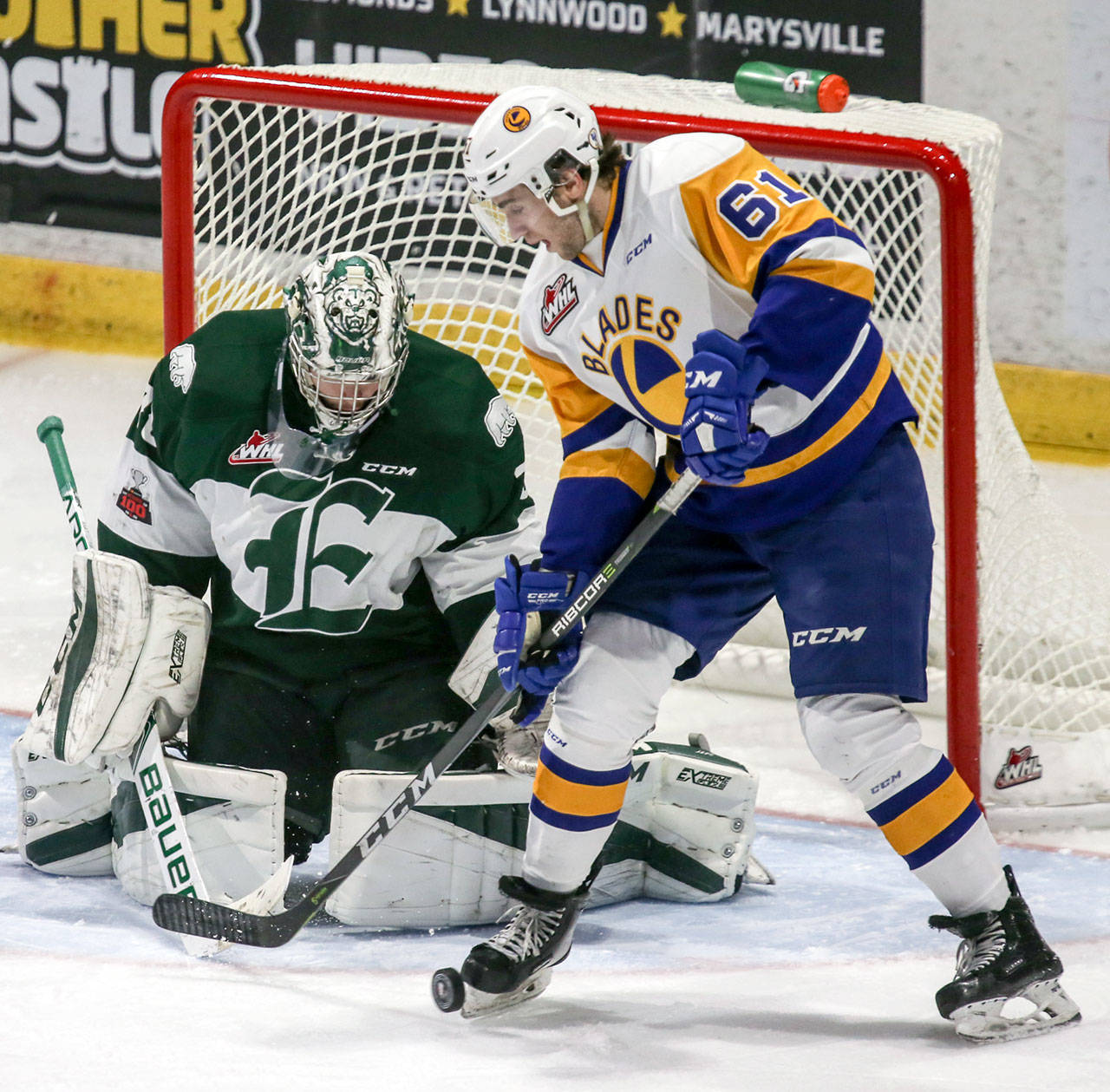 The Silvertips’ Carter Hart (left) defends the crease against Saskatoon’s Josh Paterson in the second period of a game Dec. 2, 2017, at Xfinity Arena in Everett. (Kevin Clark / The Herald)