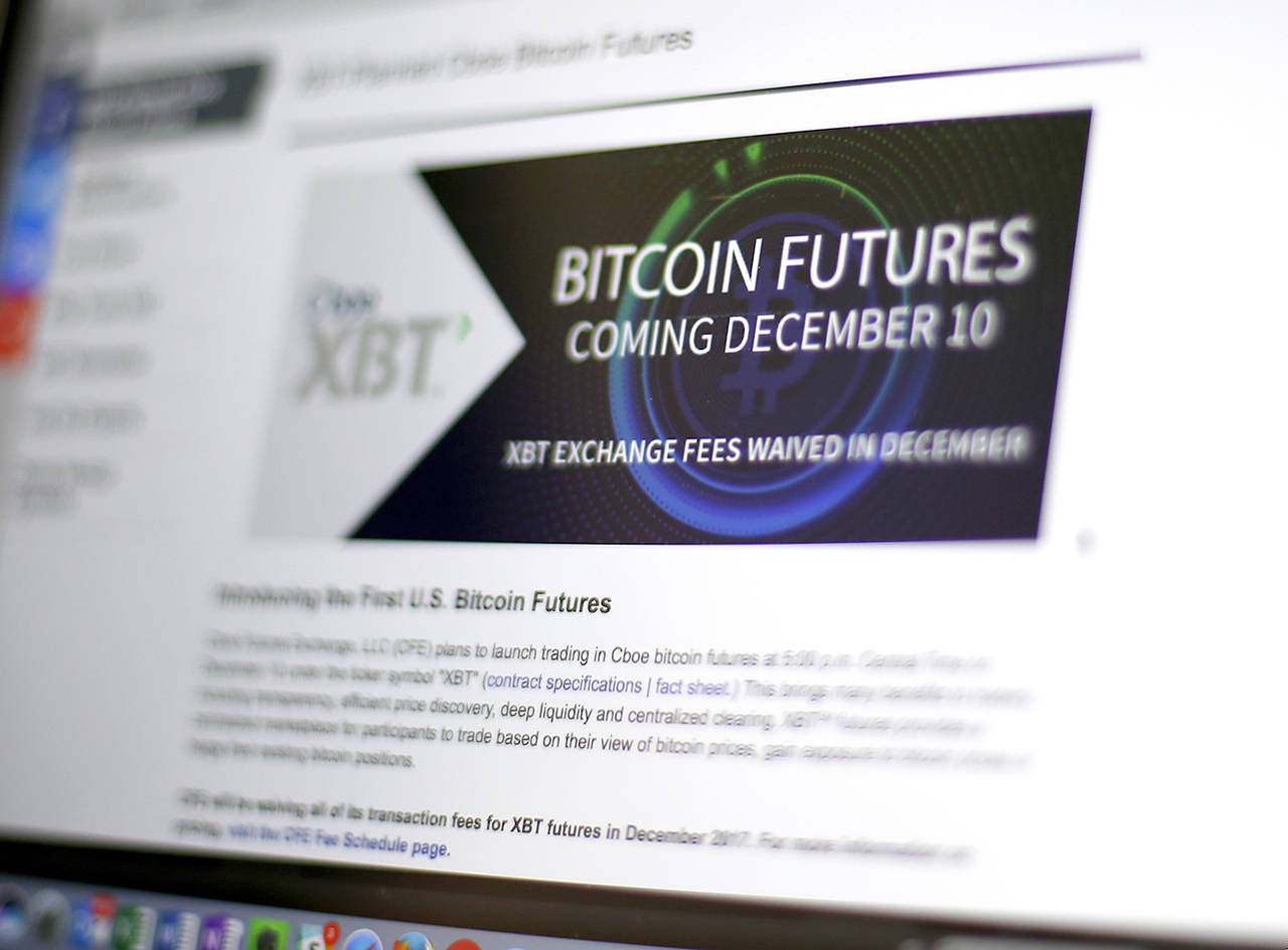 This Dec. 8 photo shows the Chicago Board Options Exchange website announcing that bitcoin futures will start trading on the CBOE on Sunday evening, Dec. 10. (AP Photo/Kiichiro Sato)