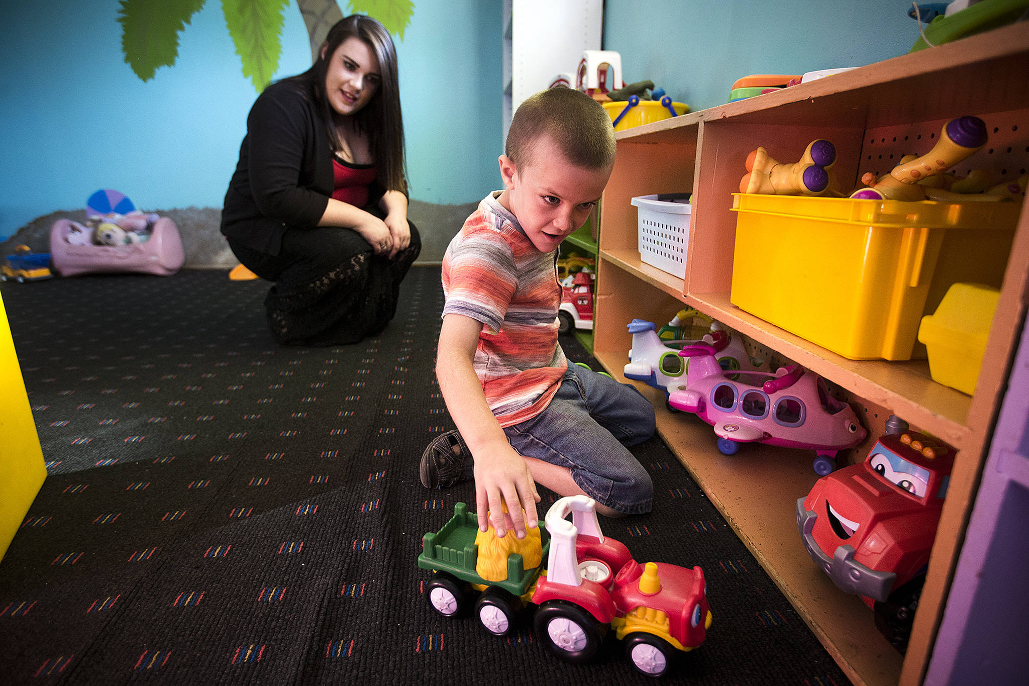 Joshua Latimer, 7, plays at Another Best Child Care in Everett while his mother, Leigh Anne Latimer, watches last September. (Ian Terry / The Herald)