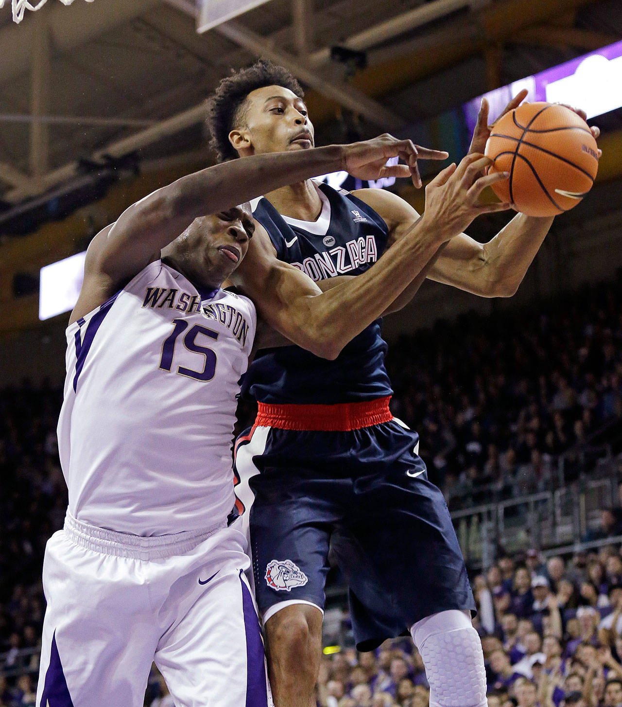 Johnathan Williams (right) grabs a rebound in front of Washington’s Noah Dickerson (15) during Sunday’s game. Williams led the Zags with 23 points. (AP Photo/Elaine Thompson)