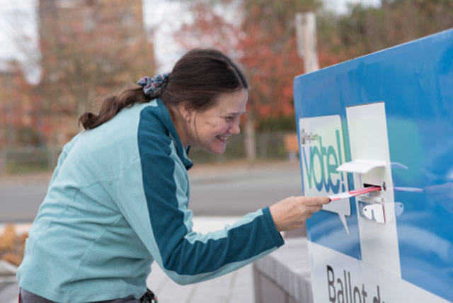 A King County voter uses a ballot drop box. (King County Elections)