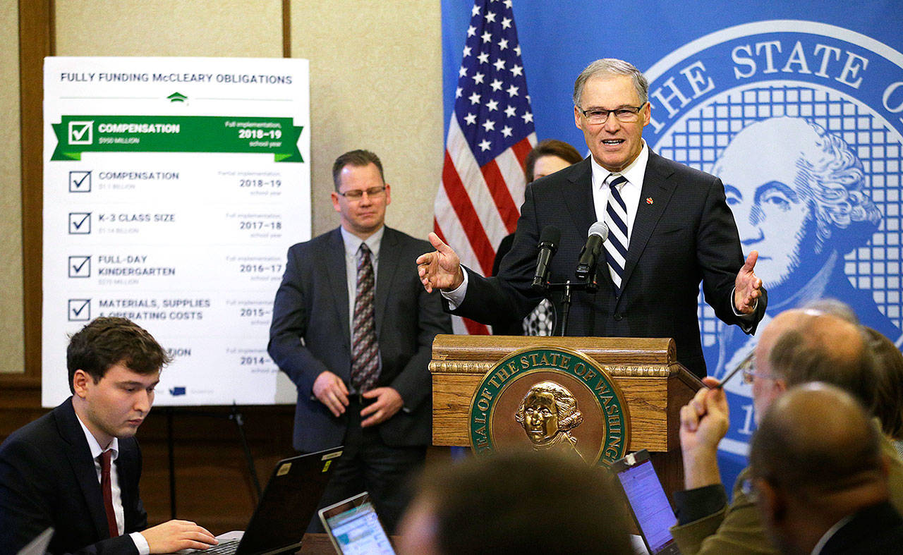 Washington Gov. Jay Inslee talks to reporters on Thursday during the unveiling of his supplemental budget proposal at the Capitol in Olympia. (AP Photo/Ted S. Warren)