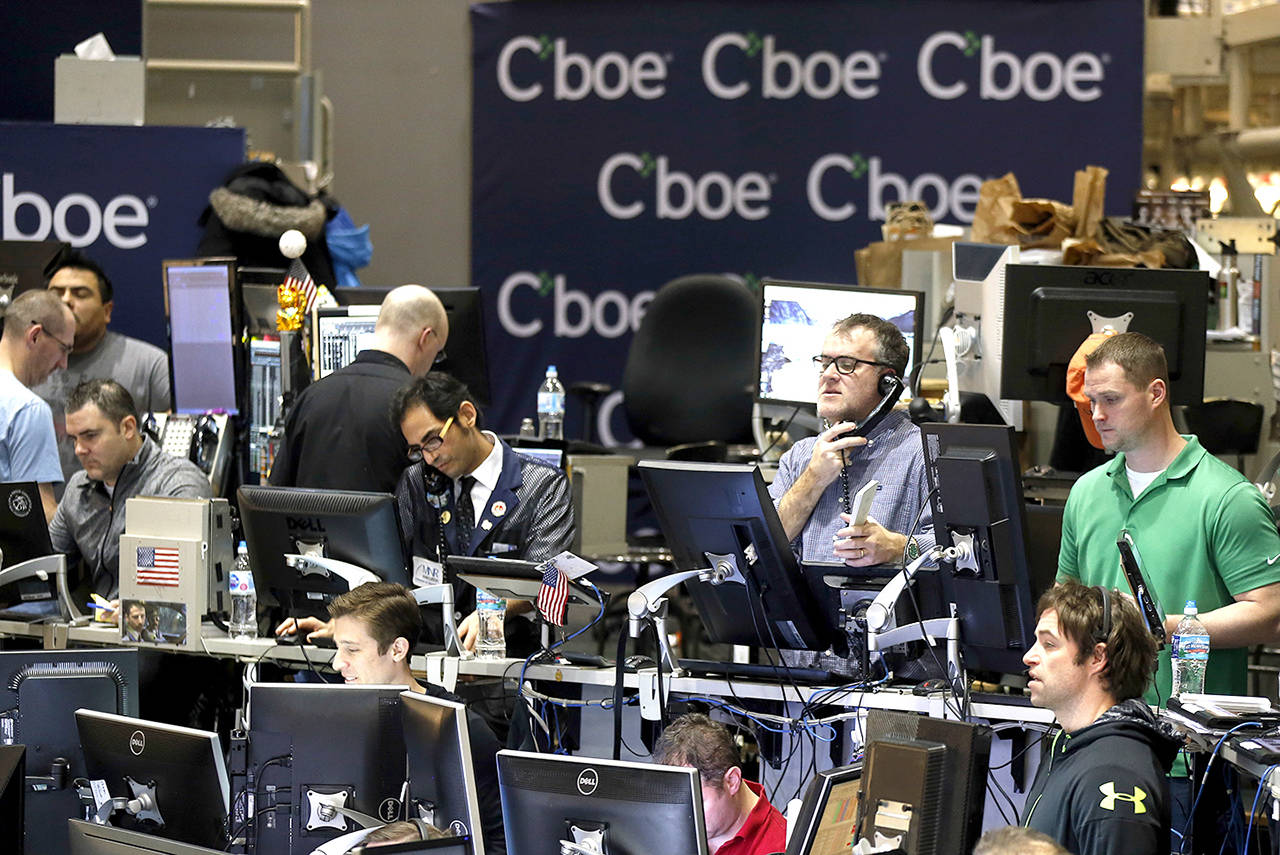 Traders work in a trading pit at the Chicago Board Options Exchange on Monday in Chicago, as they trade futures and options unrelated to bitcoin. (AP Photo/Kiichiro Sato)