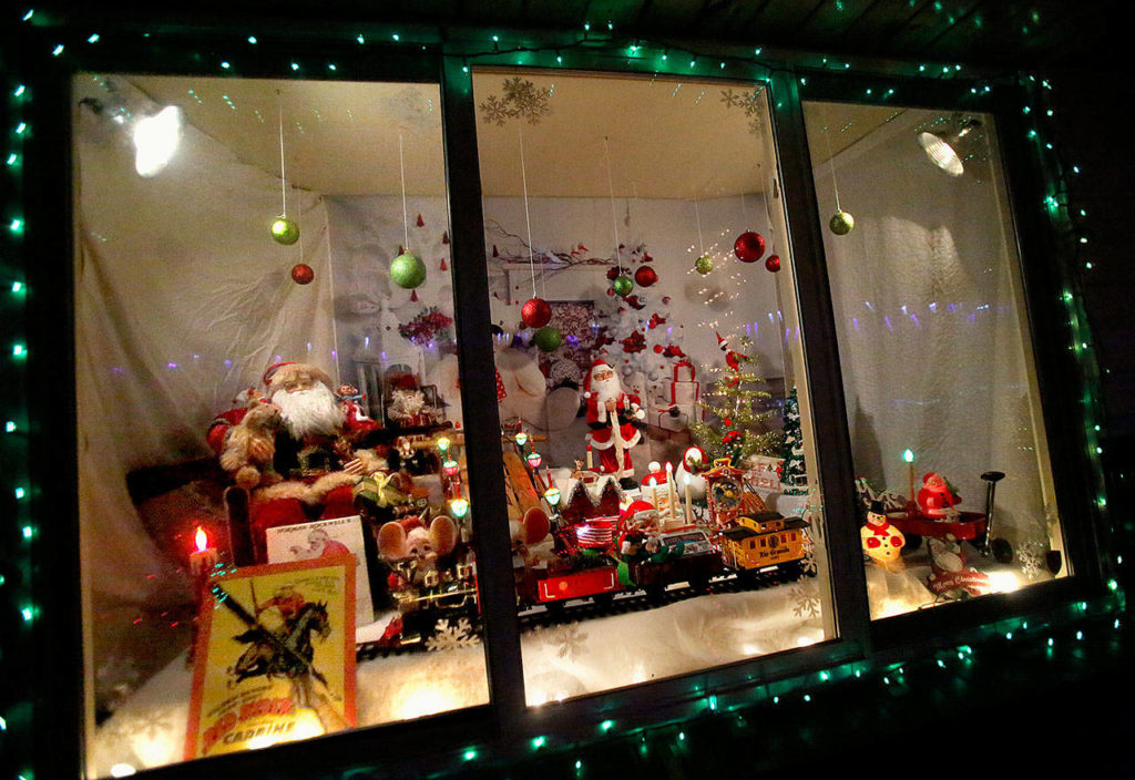 Inspired by old-fashioned store windows, a front window in the home of Kirk and Melissa Slightam has this scene that evokes the movie “A Christmas Story.” (Dan Bates / The Herald)
