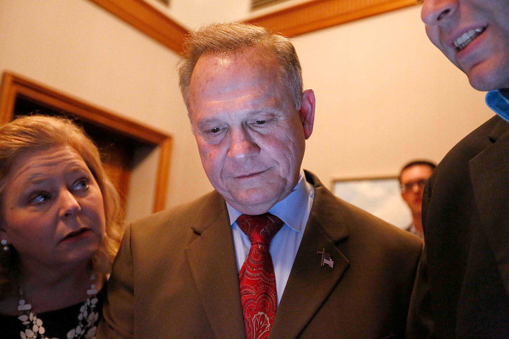 Republican U.S. Senate candidate Roy Moore (center) looks at election returns with staff during an election-night party Tuesday in Montgomery, Alabama. (AP Photo/Brynn Anderson)
