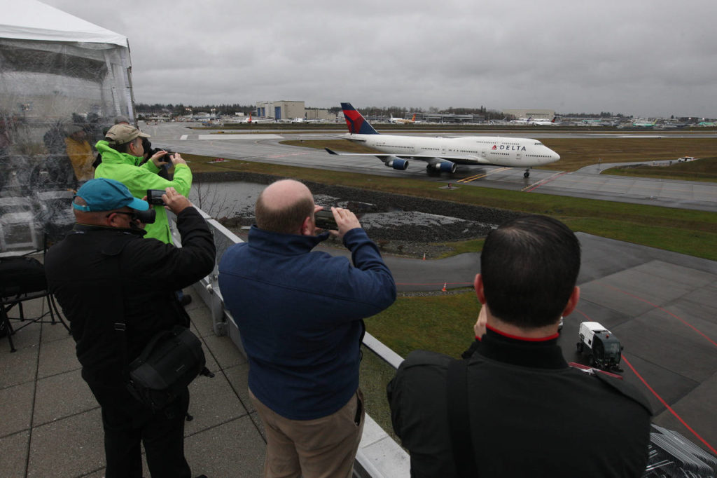 A Delta Air Lines 747 arrives at the Future of Flight Aviation Center at Paine Field during a stop on the plane’s a farewell tour on Monday. (Andy Bronson / The Herald)

