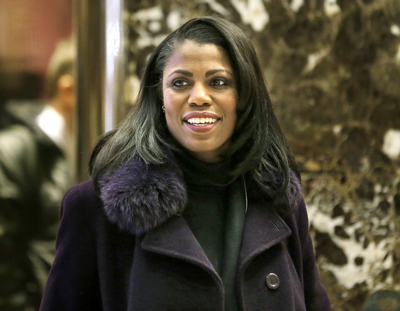 In this 2016 photo, Omarosa Manigault smiles at reporters as she walks through the lobby of Trump Tower in New York. The White House says Omarosa Manigault Newman, one of President Donald Trump’s most prominent African-American supporters, plans to leave the administration next month. (AP Photo/Seth Wenig)