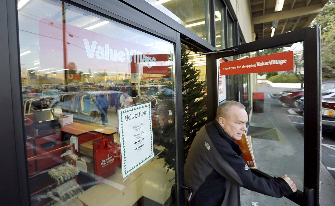 A shopper exits a Value Village store Dec. 12 in Edmonds. (AP Photo/Elaine Thompson)