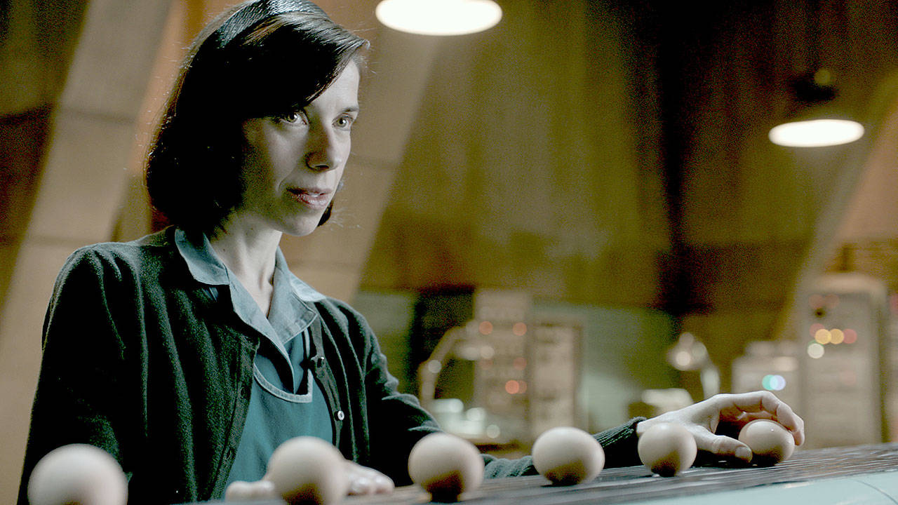 A mute cleaning woman (Sally Hawkins) offers hard-boiled eggs to the fish-man (Doug Jones) she’s befriended in Guillermo del Toro’s “The Shape of Water.” (Fox Searchlight Pictures)