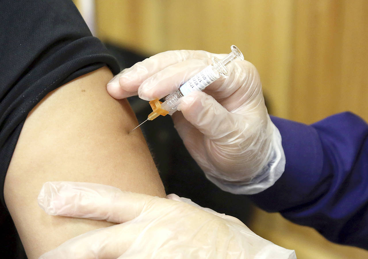 In this Sept. 22 photo, a flu vaccine injection is administered at the Brownsville Events Center by a pharmacist in Brownsville, Texas. (Miguel Roberts/The Brownsville Herald via AP)