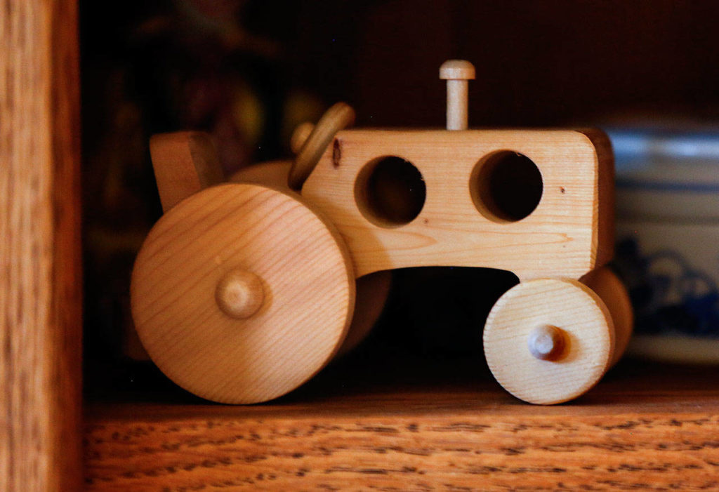 Leroy McVay has a vintage tractor in his collection of wood toys, which he donates to kids through the Volunteers of America. (Dan Bates / The Herald)
