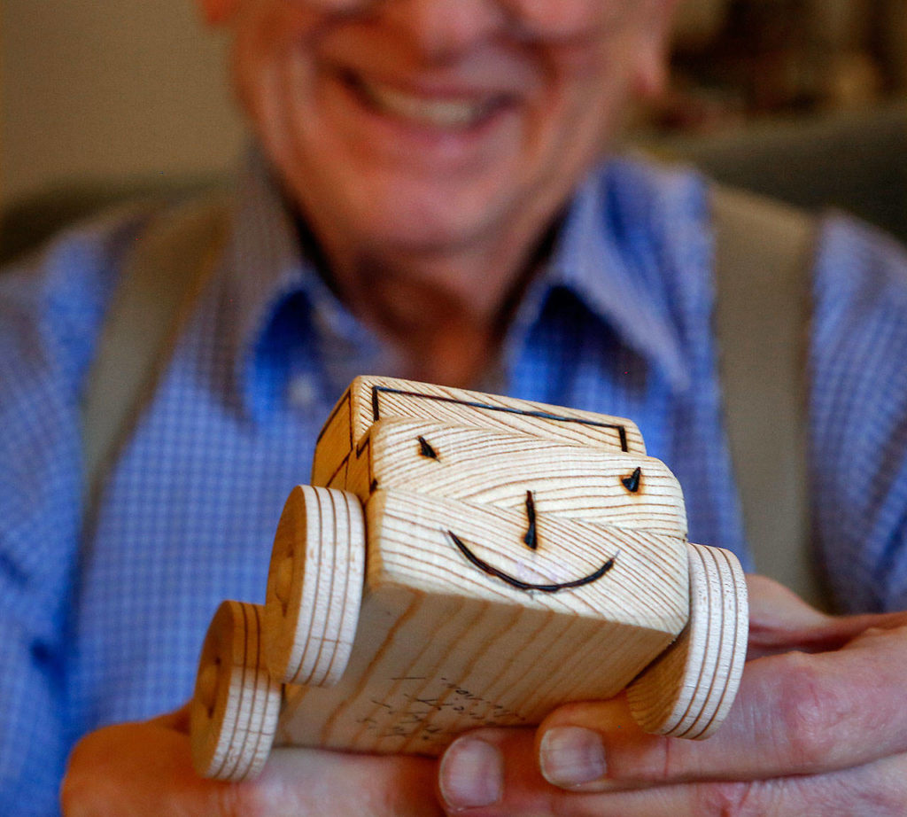 Those smiling faces on the handmade toy trucks that Leroy McVay makes tend to end up on kids. (Dan Bates / The Herald) 
