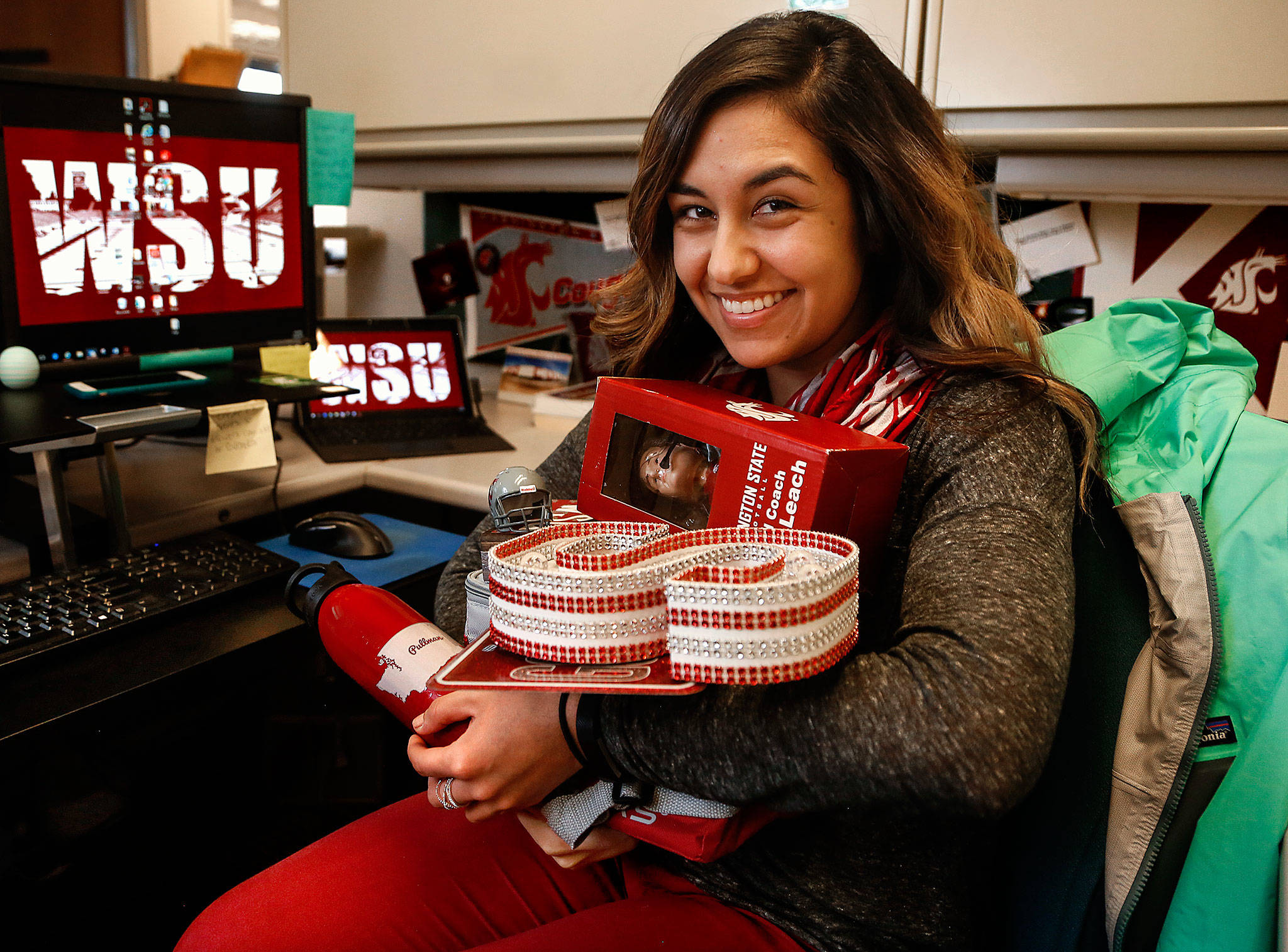 Sarah Reyes, a city of Everett communications officer, is an avid Cougar fan. Her 10th-floor city office space is pretty much tricked out in Cougar colors. (Dan Bates / The Herald)