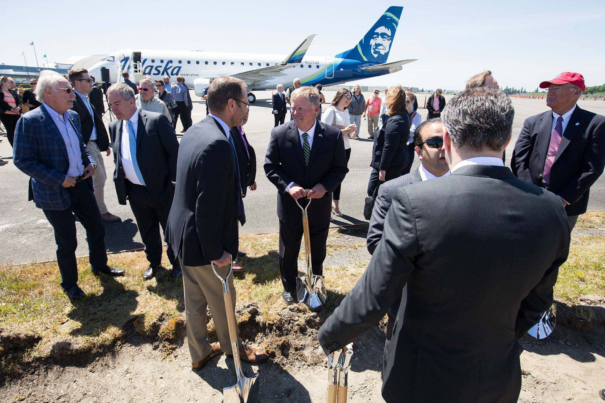 Everett Mayor Ray Stephanson (center) talks with Alaska Airlines Inc. CEO Brad Tilden after the groundbreaking ceremony for the new Paine Field passenger terminal June 5 in Everett. (Andy Bronson / Herald file)