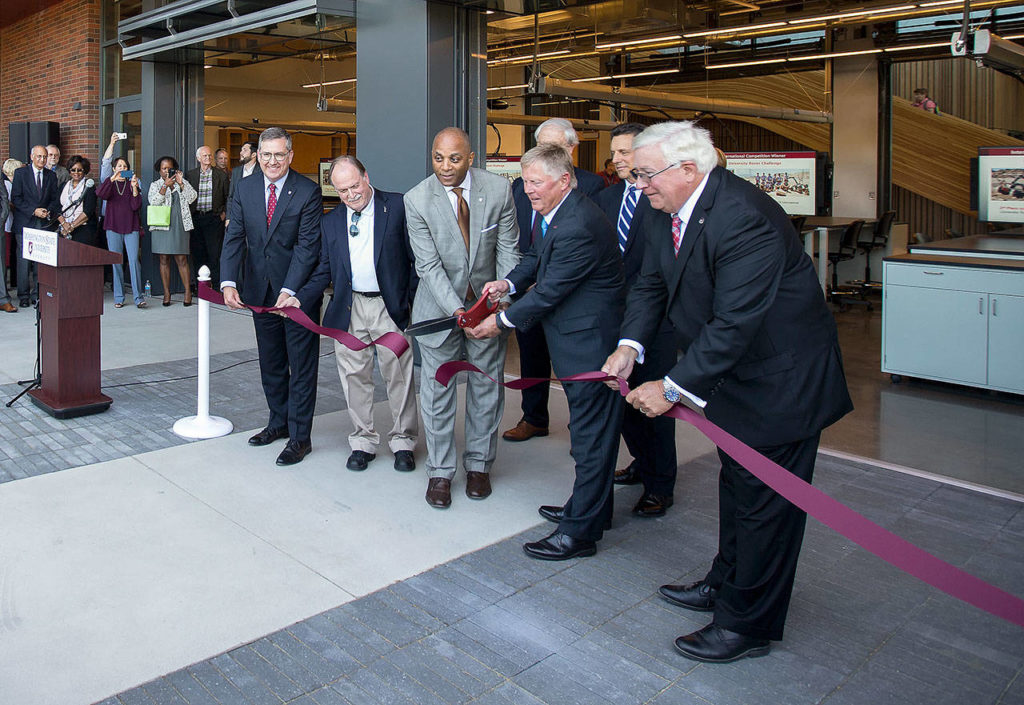 Everett Mayor Ray Stephanson (right) and Washington State University Everett Chancellor Paul Pitre cut the ribbon during an open house at the new Washington State University Everett building Aug. 15 in Everett. (Andy Bronson / Herald file)
