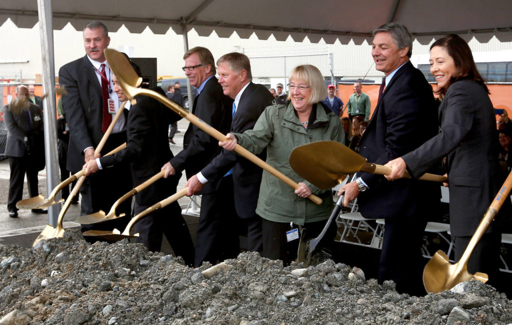 Boeing President and CEO Ray Conner (second from right), Sens. Patty Murray and Maria Cantwell and Everett Mayor Ray Stephanson (fourth from left ) mark the ceremonial beginning of construction on the Composite Wing Center at Boeing on Oct. 21, 2014 in Everett. (Herald file)
