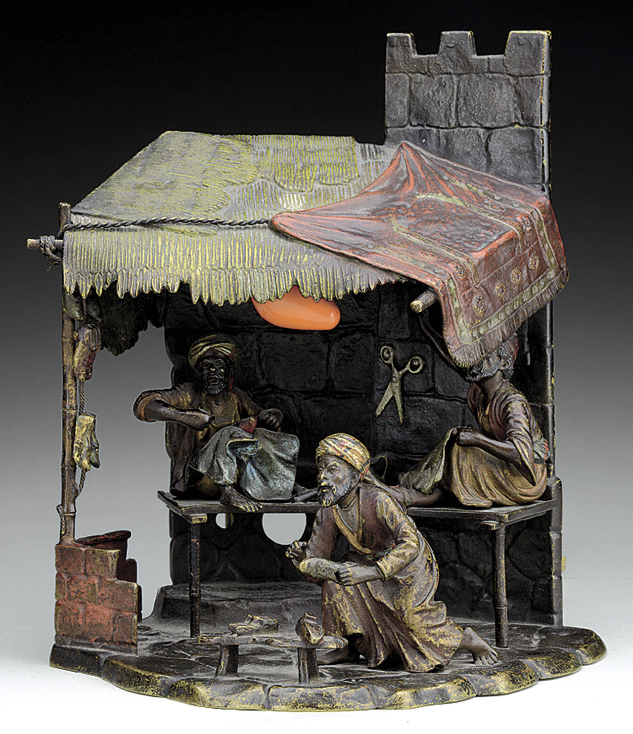 This cold-painted cobbler shop lamp, which is about 9 inches high, was offered for sale at a James D. Julia auction estimated at $2,000 to $4,000. (Cowles Syndicate Inc.)