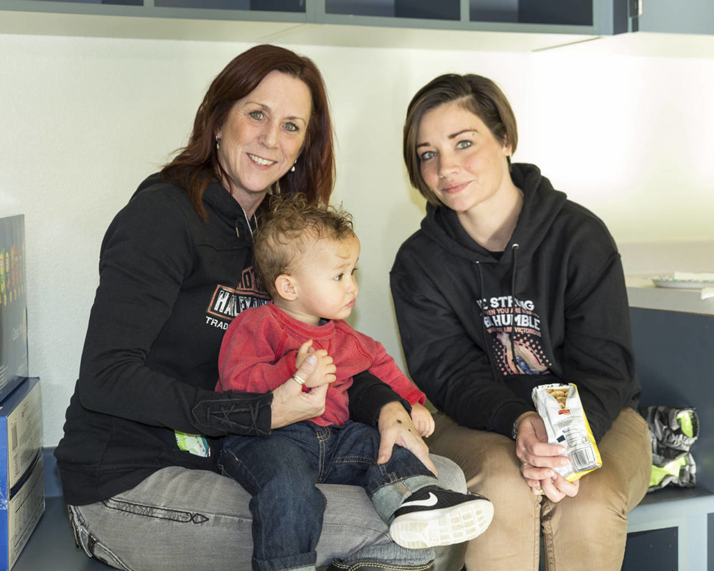 Brandii Cantrell (right) sits with her son Braden and friend Vicki Sage at the Housing Hope grand opening of Twin Lakes Landing. (William Wright/Housing Hope)
