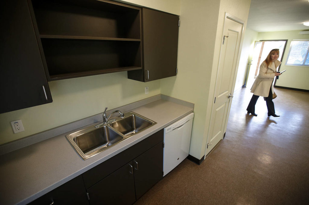 A spacious kitchen is seen in an apartment unit in Housing Hope’s new Twin Lakes Landing housing project during a public event on Friday, Dec. 8. (Ian Terry / The Herald)
