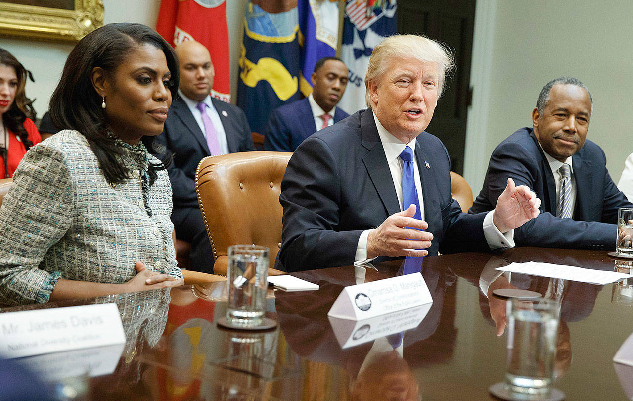 President Donald Trump speaks during a meeting on African American History Month in the Roosevelt Room of the White House in Washington on Feb. 1. From left: Omarosa Manigault, director of communications at the White House Office of Public Liaison; Trump; and then-Housing and Urban Development Secretary-designate Ben Carson. (AP Photo/Evan Vucci, File)