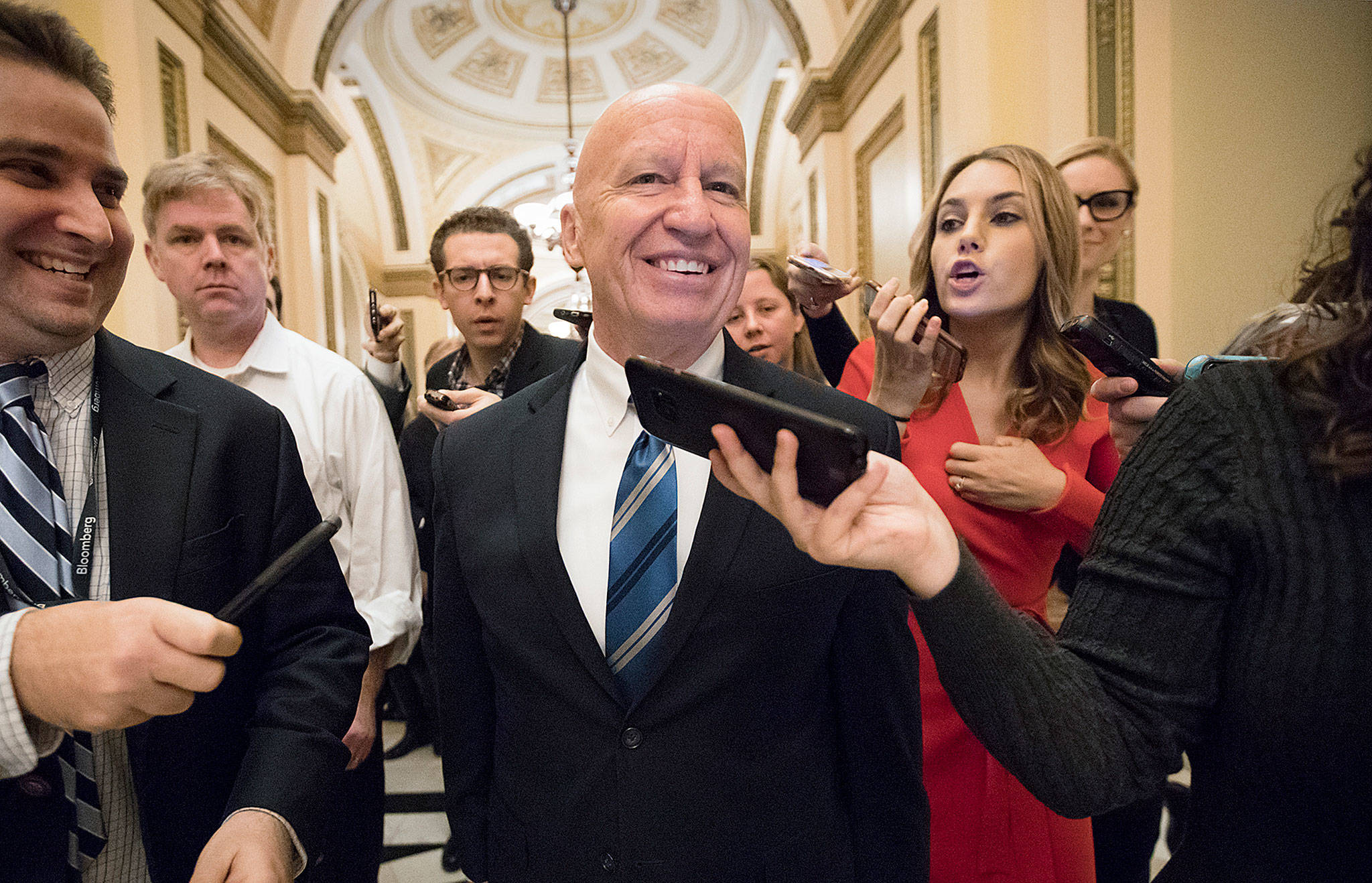 House Ways and Means Committee Chairman Kevin Brady, R-Texas, is pursued by reporters in the Capitol after signing the conference committee report to advance the GOP tax bill Friday. (AP Photo/J. Scott Applewhite)