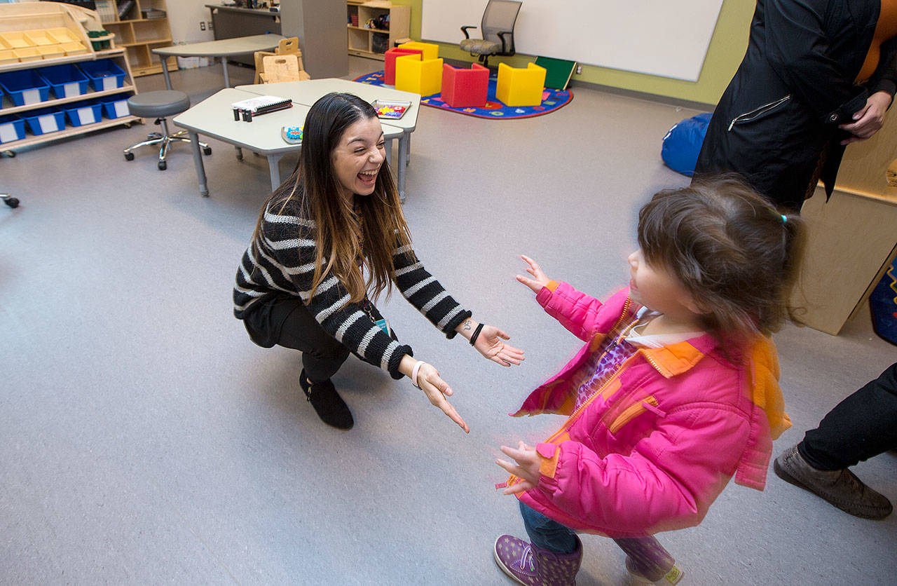 Michaela Andrade rushes to hug her former teacher, Maya Garcia, during an open house for students at the new Lake Stevens Early Learning Center on Friday in Lake Stevens. (Andy Bronson / The Herald)
