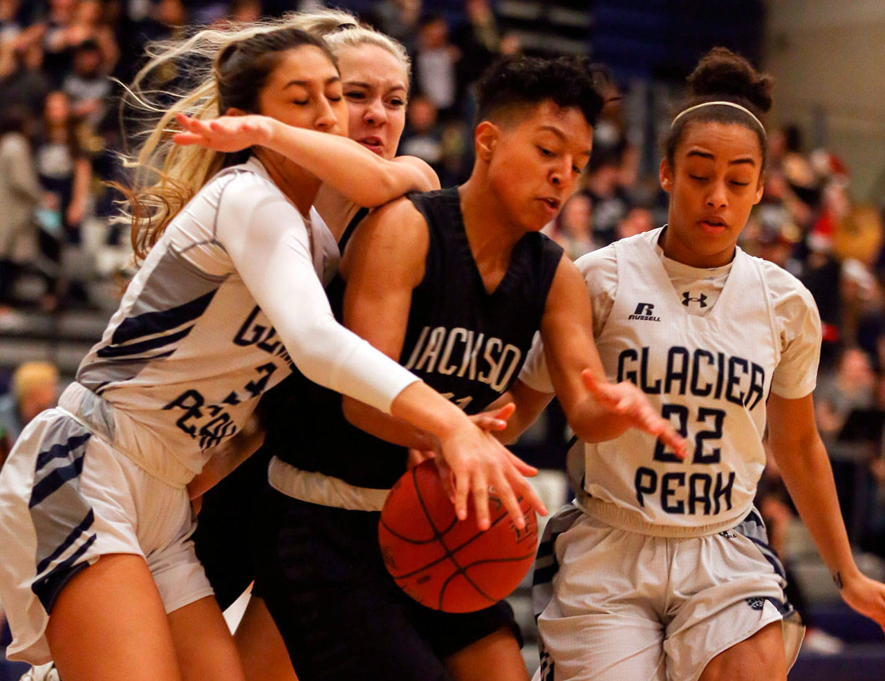 From left, Glacier Peak’s Makayla Guerra, Jackson’s Lauren Schillberg, Jackson’s Breonna Williams and Glacier Peak’s Aaliyah Collins vie for a loose ball Friday in Snohomish. (Kevin Clark / The Daily Herald)
