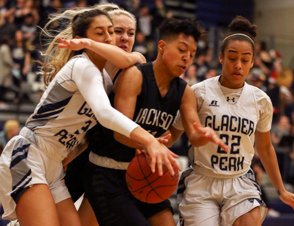 Glacier Peak’s Makayla Guerra (left), Jackson’s Lauren Schillberg (rear), Jackson’s Breonna Williams (center) and Glacier Peak’s Aaliyah Collins (right) vie for a loose ball during a game Dec. 15, 2017, at Glacier Peak High School in Snohomish. (Kevin Clark / The Daily Herald)
