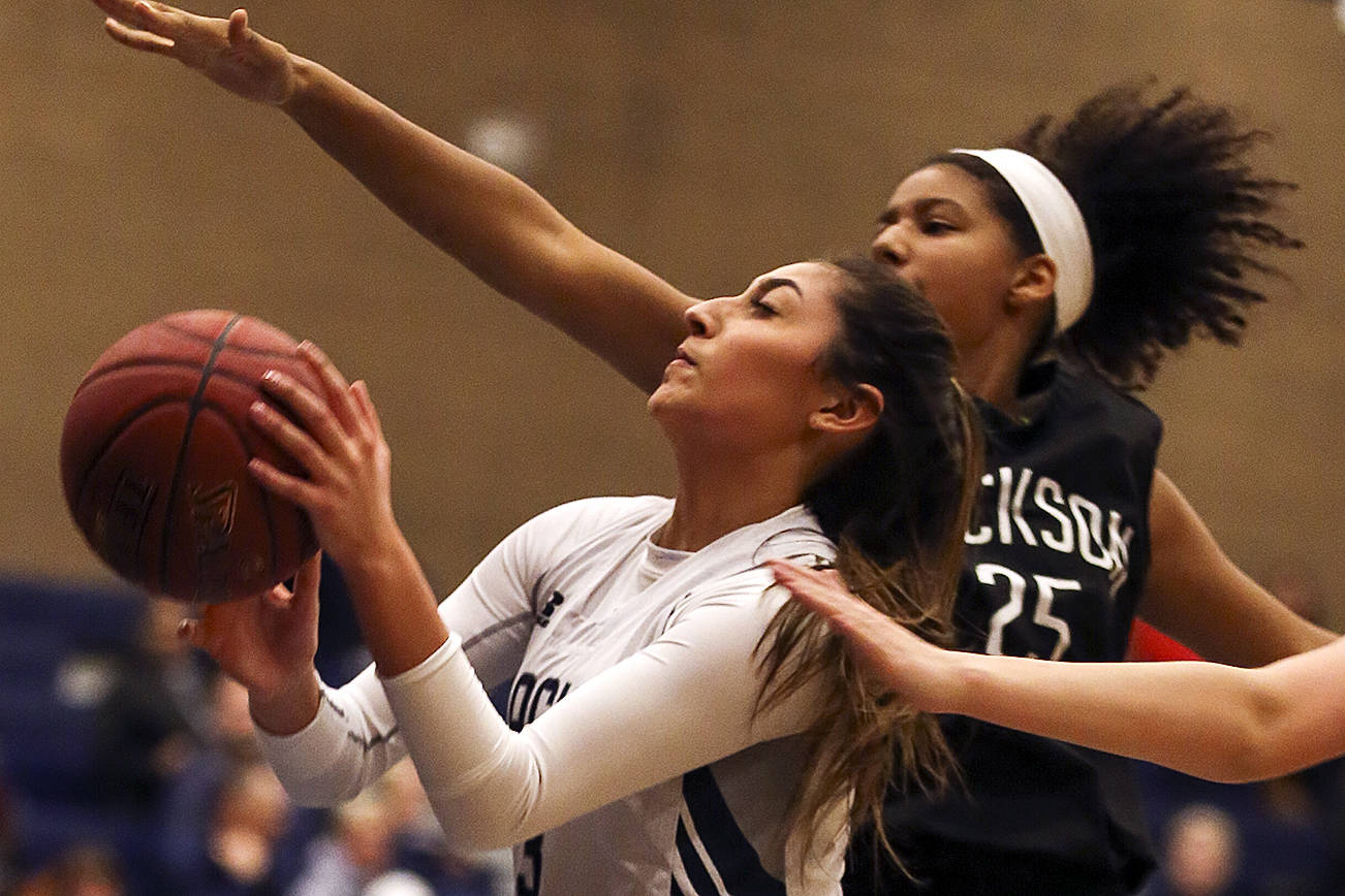 Glacier Peak’s Makayla Guerra attempts a shot past Jackson’s Sydney Carter Friday night at Glacier Peak High School in Snohomish on December 15, 2017. Glacier Peak won 63-46. (Kevin Clark / The Daily Herald)