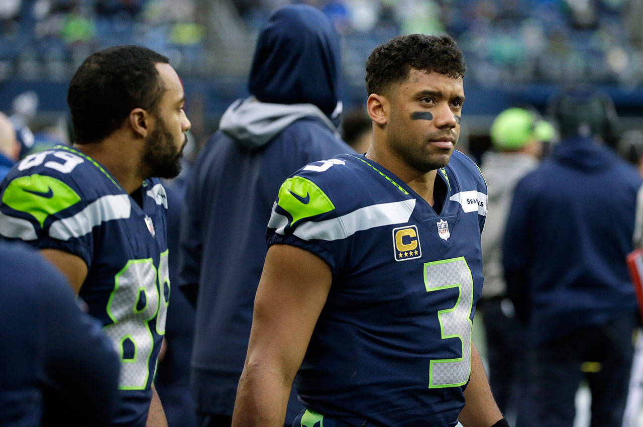 Seattle Seahawks quarterback Russell Wilson (righ) and wide receiver Doug Baldwin (left) stand on the sideline during the second half of Sunday’s NFL game in Seattle. (AP Photo/Elaine Thompson)