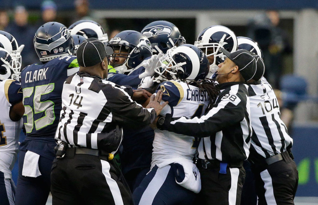 Officials try to break up a scuffle in the second half of Sunday’s game between the Seattle Seahawks and the Los Angeles Rams. Seattle Seahawks strong safety Delano Hill was ejected from the game after the altercation. (AP Photo/Elaine Thompson)
