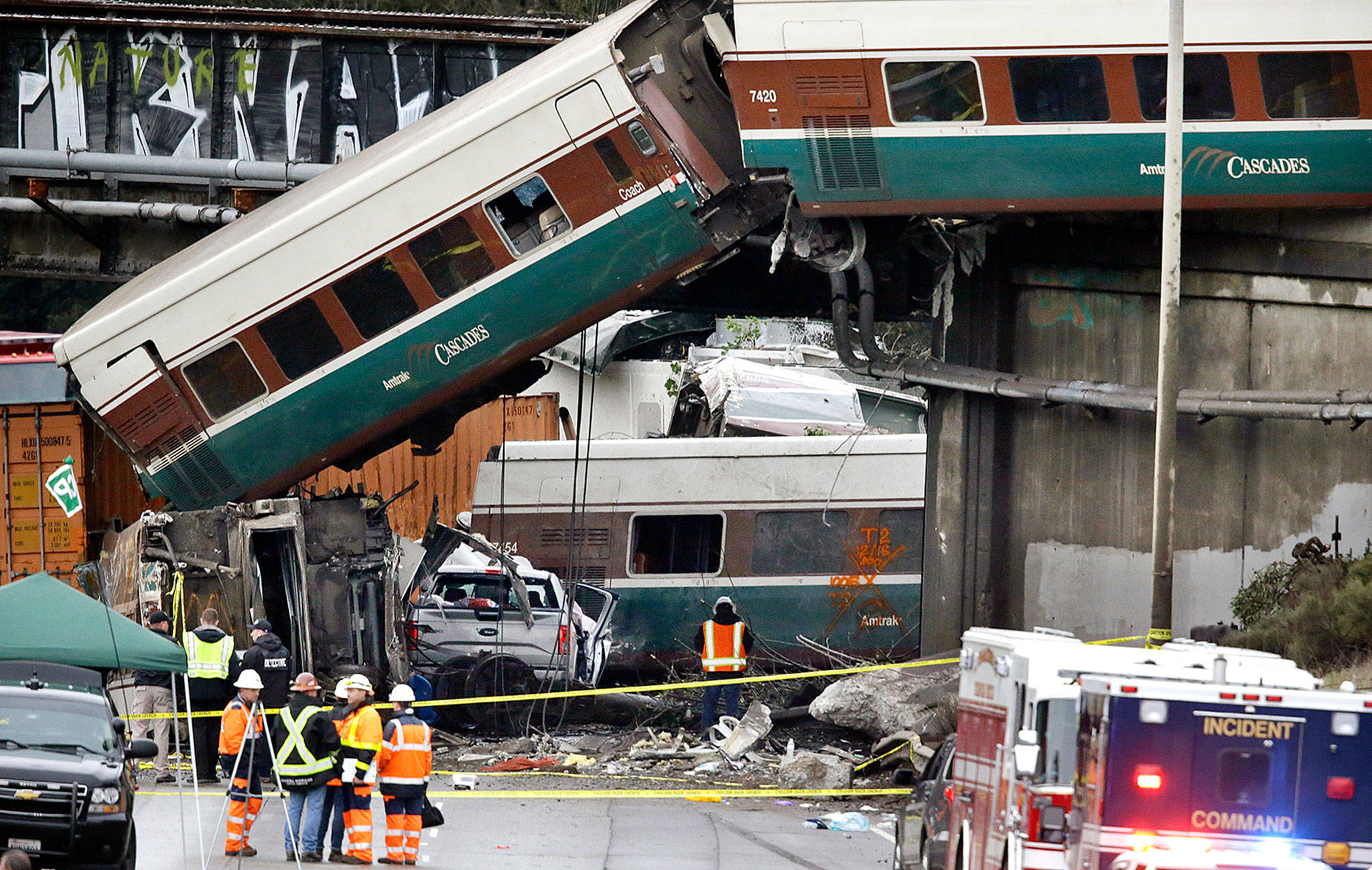 Cars from an Amtrak train spilled onto Interstate 5 after a derailment Monday near DuPont. (AP Photo/Elaine Thompson)