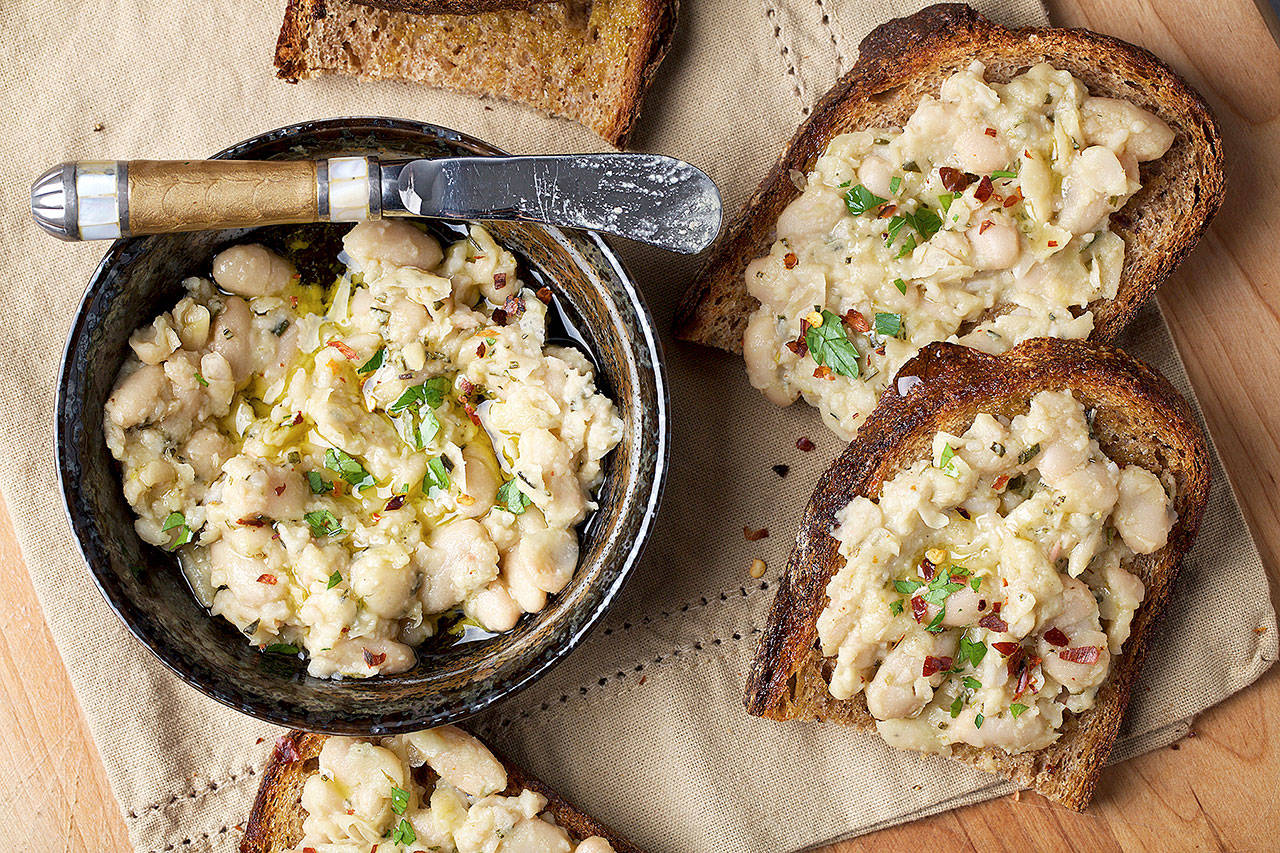 Garlic-rosemary white bean toasts take all of 15 minutes to whip up with ingredients that are easy to keep on hand — so it’s perfect for surprise guests. (Photo by Deb Lindsey for The Washington Post)