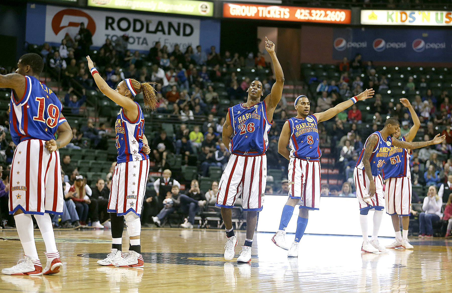 Members of the Harlem Globetrotters wave to the crowd during a visit to Everett in 2014. (Jennifer Buchanan / The Herald)