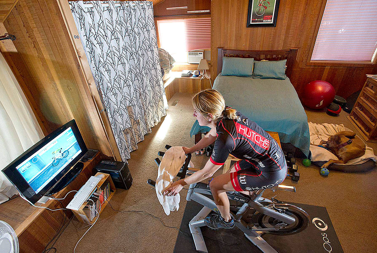 Erin Reis uses Zwift, a virtual bicycle riding and racing simulator, at her home in Bend, Oregon. (Ryan Brennecke/Bulletin photo)