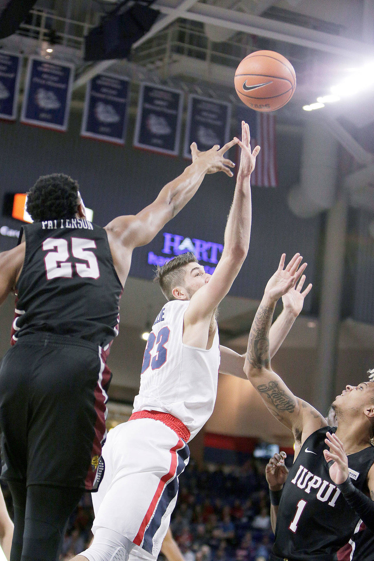 Gonzaga’s Killian Tillie (33) shoots between IUPUI’s Ron Patterson (25) and T.J. Henderson (1) during the first half of the No. 12 Bulldogs’ 101-71 win Monday in Spokane. (AP Photo/Young Kwak)